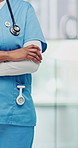 Hands, nurse and arms crossed in hospital for healthcare, medical service and responsibility. Person, clinic employee and confident in lobby with integrity, wellness representative and cardiology