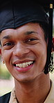 Smile, graduation and face of man with cap at university for goal, education or academic achievement. Happy, portrait and graduate student in mortarboard with pride for college milestone at campus.
