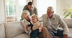 Online, child and grandparents with phone in lounge, entertainment and watching cartoons on website. Streaming, movie and people with toddler in house, happy and family with mobile in living room