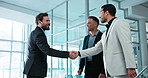 Business, partnership and men in office with handshake, greeting and welcome gesture in b2b deal. Smile, networking and employees with shaking hands, introduction and opportunity for collaboration.
