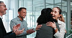 Business, people and hug in office with applause, good news and congratulations for promotion. Smile, women and embrace in workplace for teamwork, partnership and celebration for employee recognition