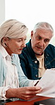 Documents, discussion and senior couple in home with planning for retirement funds or budget. Paperwork, conversation and elderly people with finance report for expenses, pension or asset management.