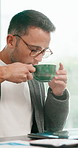 Man, coffee and remote work in home with laptop, thinking and complete financial management report. Freelancer, person typing and finish finance task in house with computer, warm drink or reflection.