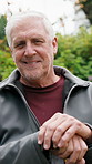 Senior, face or happy man with cane in nature for retirement, wellness or vitality in outdoor garden. Portrait, elderly or male person with walking stick for support, mobility or healthcare in park