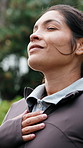 Happy, woman and breathing exercise in nature for spiritual wellness, outdoor healing or fresh air. Calm, female person or awareness with smile or zen for health, vitality or mindfulness in park