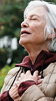 Senior, woman and breathing exercise in nature with relief for spiritual wellness or outdoor fresh air. Elderly, female person or smile with zen for health, vitality or mindfulness in garden or park