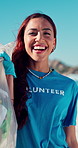 Trash bag, happy and face of volunteer on beach for recycle, clean or waste management. Garbage, woman and portrait of ngo worker by ocean for dirt collection, reduce pollution or community service.