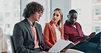 Business, people and document in waiting room for interview, application and resume for hiring. Team, candidates and talking in office with paperwork, review cv and recruitment process for onboarding