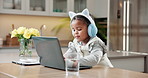 Laptop, headphones and kid in home for elearning, typing and streaming video for knowledge growth. African girl, computer and audio for education, music course and online class for development