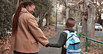 Mother, walk and holding hands outdoor with school child, connection and support for education goals. Back, happy black woman and son in neighborhood with safety, learning skill or commute to academy