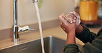 Child, soap and washing hands by kitchen sink in home for hygiene, wellness and bacteria prevention. Kid, running water and tap in house for skincare, health and disinfection for cleaning with foam