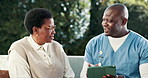 Happy, old woman and nurse with tablet, outdoor or discussion with healthcare report at nursing home. Senior care, caregiver and black people with technology, laughing and health update for patient