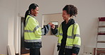 Architect, team or happy on construction site for fist bump, building progress or inspection pass. Tech, women or celebration for architecture goal, permit clearance or success of renovation deadline
