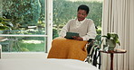 Tablet, relax and black woman in wheelchair at house with research, social media or reading blog. Digital technology, smile and mature person with disability on website for article on news in home.