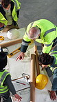 Construction, team and people with blueprint for planning, development layout or project schematic. Document, top view and collaboration with engineer at site, building design or floor plan review