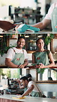 Face, people and series at cafe with smile, phone payment and inventory update for hospitality. Portrait, team and barista at coffee shop with tablet, cleaning counter and pos machine for transaction