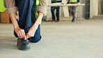 Construction, boots or hands on site with tie, ppe regulation or protection gear in building safety. Space, woman and engineer with shoelaces, risk control or hazard prevention in industrial industry