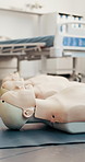 Room, CPR and medical with training dummy for paramedic course, coaching or emergency service. Empty, equipment or preparation with mannequin or dolls for recovery practice or save a life in hospital