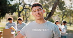 Charity, face and volunteer man in park for support, community service or food donation for relief. About us, NGO and portrait with person for help, aid package and grocery distribution in nonprofit