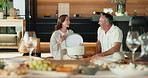 Happy, gift and mature couple in home to celebrate birthday, anniversary or giving for love. Sofa, surprise and man with present, embrace and bonding with woman for appreciation or marriage milestone