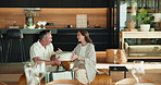 Surprise, gift and mature couple in home to celebrate birthday, anniversary or giving for love. Sofa, happy and man with present, embrace and bonding with woman for appreciation or marriage milestone