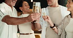 People, hands and cheers with champagne in home for get together, dining event or social gathering. Happy, group or friends with toast, alcohol or glass for celebration or holiday dinner in house