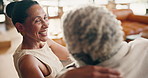 Laugh, relax and couple on sofa for conversation, talking and chat for bonding, love and marriage. Home, happy and mature man and woman on couch for connection, commitment or interracial relationship