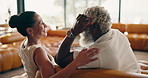 Happy, relax and couple on sofa for conversation, talking and chat for bonding, love and marriage. Home, care and mature man and woman on couch for connection, commitment and interracial relationship