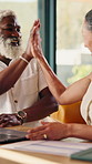 Finance, investment and interracial couple with high five in home for success or asset management. Man, woman or smile with laptop or documents for financial budget, winning or expenses in house