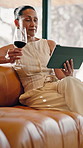 Tablet, wine and mature woman on sofa for internet, social media and relax with drink on weekend. Happy, home and person on digital tech with alcohol for me time, website and reading ebook for break