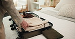 Clothes, suitcase and woman packing in hotel for travel, accommodation and check out in room. Hospitality, lodge and person with clothing, luggage and bag for business trip, reservation or booking