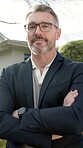 Face, arms crossed and real estate agent at property for handover, home ownership or glasses. Happy, mature person or realtor with smile for sale, lease or rent house from seller or landlord to buyer