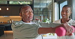 Old woman, stretching and physio at house with dumbbells, mobility and muscle strength for recovery. Physiotherapist, helping and senior person in lounge for fitness, physiotherapy and rehabilitation
