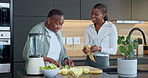 Blender, ingredients and senior mother with adult daughter for wellness, discussion or fruit in home. Black women, elderly mom and smoothie recipe in kitchen with healthy diet, help and cut cucumber.