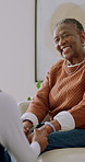 Old woman, laugh and holding hands with daughter in home, connection and bonding together in lounge. Family, smile and support for senior black person, love and happy with mother in living room