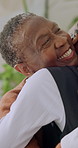 Old woman, smile and hug with daughter in house, discussion and together on weekend in living room. Senior parent, embrace and family connection on break, support and happy black people in lounge