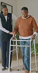 Happy, help and old person with walker and nurse for physical therapy, walking and exercise in house. Senior woman, caregiver and mobility aid frame with patient assistance, steps and healthcare