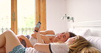 Friends, phone and laughing for funny online in bedroom, communication and happy for comic on social media. Women, meme and streaming joke on technology, relaxing and bonding on weekend at home