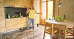 Music, dance and woman singing in a kitchen with energy, motion and having fun in her home. Radio, freedom and female person with morning karaoke in a house moving to audio, sound or streaming track