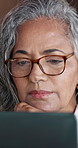 Woman, thinking and remote work in house with laptop, glasses and review online real estate advert. Realtor, mature person and vision in home with computer, hybrid job and planning to sell property.