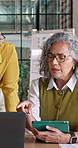 Woman, discussion and laptop with team in office for performance management, review or statistics. Female person, conversation or group with technology or documents for business finance in workplace