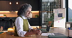 Remote work, writing and woman with laptop in house, accountant and tax preparation with paperwork. Freelance, senior bookkeeper and person with tech for budget, notes and financial report in home