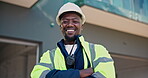 Engineer, face and happy man with arms crossed, construction site and confident with career growth. Civil engineering, portrait and black person with helmet, low angle or laugh for renovation project