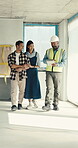 Engineer, tablet and discussion with couple in building, walking and planning for home improvement. House, renovation and talk with happy people, point and contractor with tech on construction site