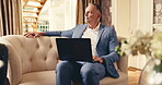 Business travel, man and thinking with laptop in hotel, research or review market update on website. Senior investment banker, reflection and happy person with tech, luggage and international trip