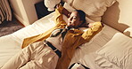 Bed, woman and relax in hotel room for business travel fatigue, comfort and unwind with thinking. Cozy, happy guest or rest on above for post work trip, downtime reflection or decompress from jet lag