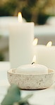 Spa, empty and towel with candles at resort for aromatherapy, skincare treatment and wellness. Pamper, background and flame for herbal scent, holistic therapy or stress relief for therapeutic massage