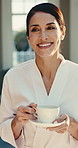 Resort, holiday and happy woman with coffee, thinking and rest with hot beverage on break or travel. Drinking, tea and reflection with smile on vacation, calm and mature person with robe on weekend