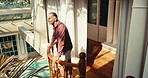 Resort, balcony and senior man with smile, holiday and sightseeing on weekend, thinking and tourism. Happy, tourist and retired person on break, positive attitude and reflection on vacation in hotel