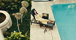 Relax, pool and woman at hotel on chair for break, rest and chill on holiday, getaway or retreat. Hospitality, above and person with juice, food and sunbathing for vacation, weekend and summer